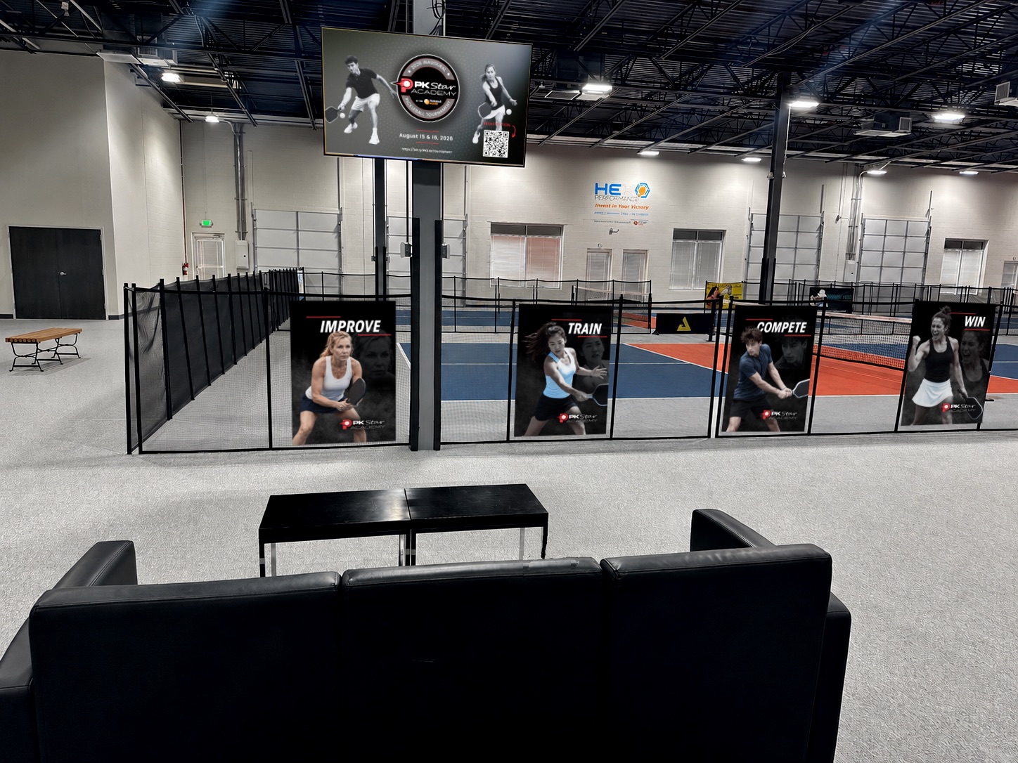 Court 7 with PK Star Academy fence banners and overhead screen